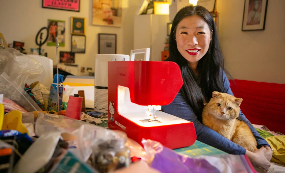 Performance artist Kristina Wong poses in March 2021 in the sewing room of her apartment in Koreatown, Los Angeles, when she was leading the Auntie Sewing Squad Facebook group that sewed masks for those who needed them. (Jason Armond/Los Angeles Times)