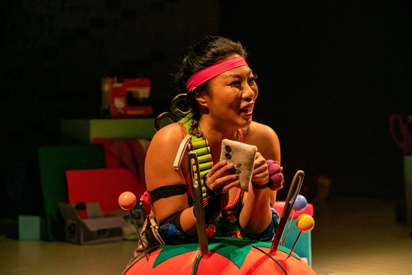 Kristina Wong in La Jolla Playhouse’s production of KRISTINA WONG, SWEATSHOP OVERLORD